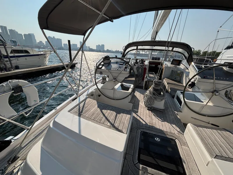 Slide: The Image of 2014 Southerly 535 yacht cockpit with dual steering wheels, docked in a marina. - 8