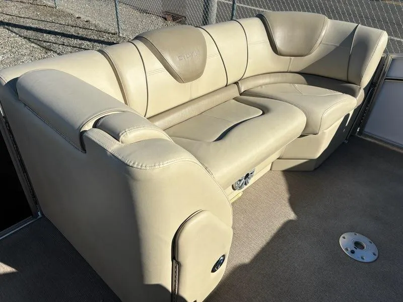 Slide: The Image of 2018 Sylvan S3 boat interior with beige leather seating and speaker. - 10