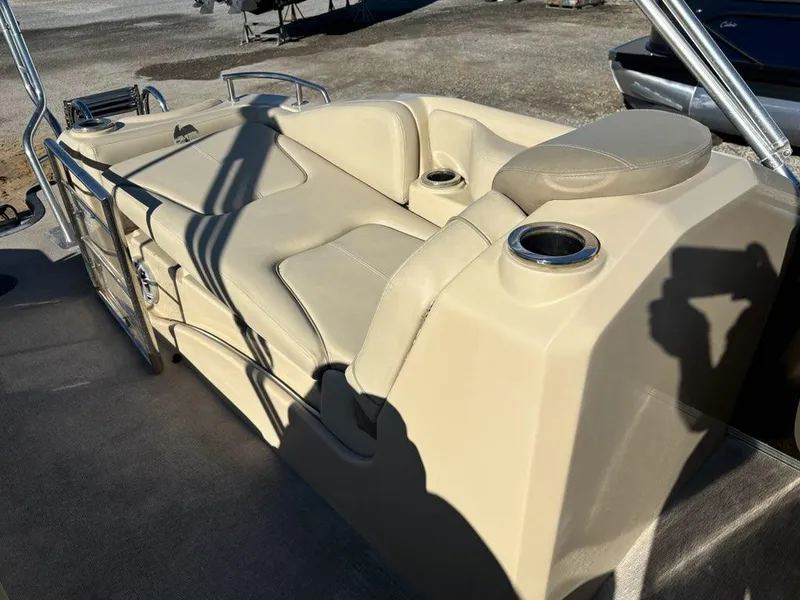 Slide: The Image of 2018 Sylvan S3 boat interior with beige seating and cup holders. - 13