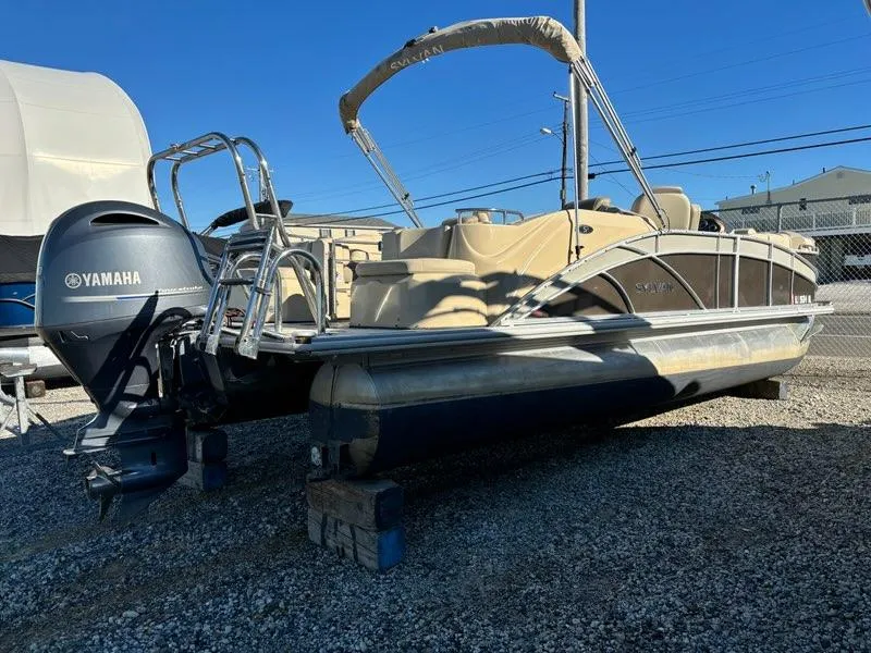 Slide: The Image of 2018 Sylvan S3 pontoon boat with Yamaha outboard motor on gravel lot. - 3