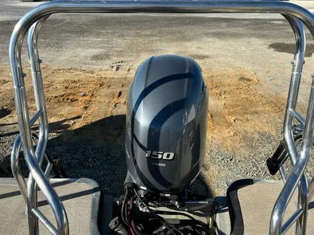 Slide: The Image of 2018 Sylvan S3 boat with Yamaha 150 outboard motor, parked on gravel. - 4