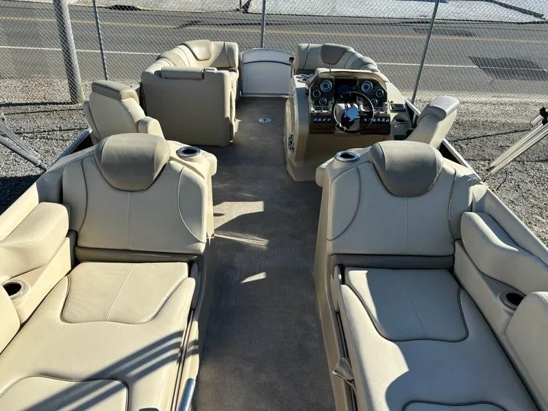 Slide: The Image of 2018 Sylvan S3 boat interior with beige seating and modern dashboard. - 5