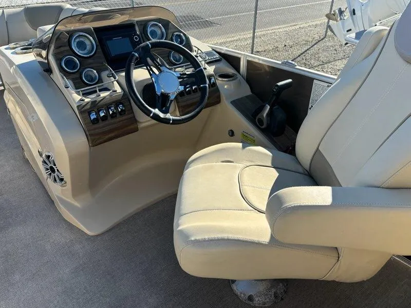 Slide: The Image of Captain's seat and control panel of a 2018 Sylvan S3 boat, featuring modern gauges and steering wheel. - 6