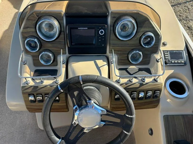 Slide: The Image of Dashboard of a 2018 Sylvan S3 boat with steering wheel and control gauges. - 7