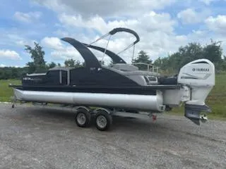 Slide: The Image of 2020 Bennington 24RTSBA pontoon boat with Yamaha engine on trailer, outdoors. - 11