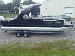Slide: The Image of 2020 Bennington 24RTSBA pontoon boat on trailer, parked outdoors. - 12