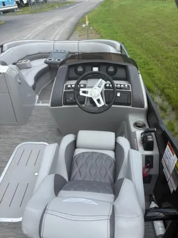 Slide: The Image of 2020 Bennington 24RTSBA boat interior with steering wheel and seating, featuring modern design. - 19