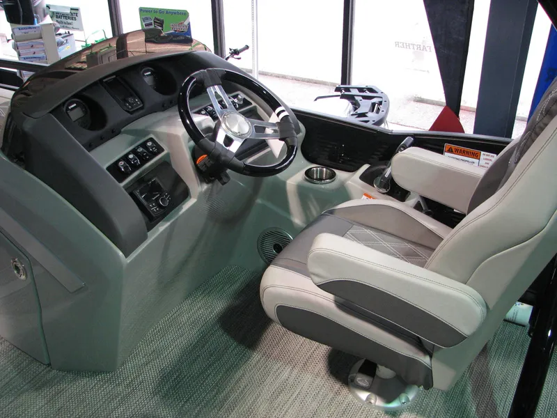 Slide: The Image of Captain's seat and helm of 2020 Bennington 24RTSBA boat, featuring modern controls and steering. - 6