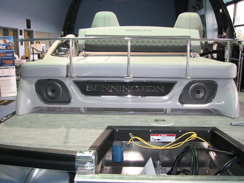 Slide: The Image of 2020 Bennington 24RTSBA pontoon boat with speakers and seating area. - 8