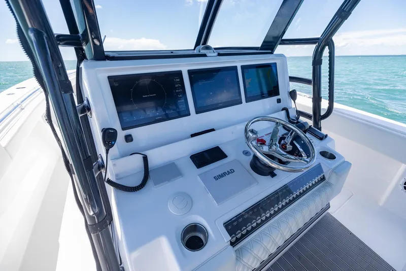 Slide: The Image of 2025 Invincible 43 Open Fisherman boat dashboard with advanced navigation screens and controls. - 15