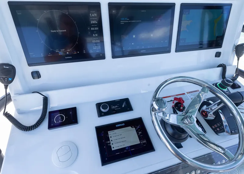 Slide: The Image of 2025 Invincible 43 Open Fisherman helm with advanced navigation displays and controls. - 17