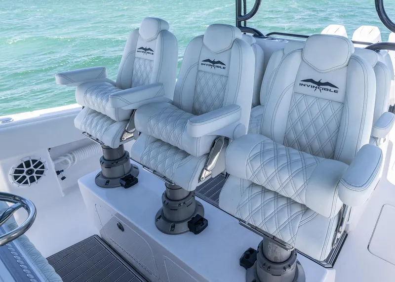 Slide: The Image of Luxurious seating on 2025 Invincible 43 Open Fisherman boat, featuring elegant white upholstery. - 19