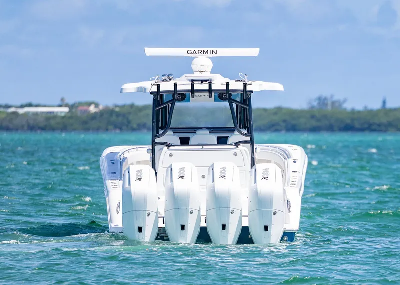 Slide: The Image of 2025 Invincible 43 Open Fisherman boat with four engines on the water. - 2