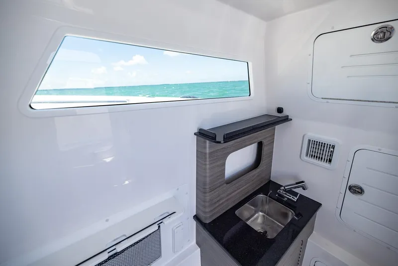 Slide: The Image of Interior of 2025 Invincible 43 Open Fisherman boat with sink and ocean view. - 27