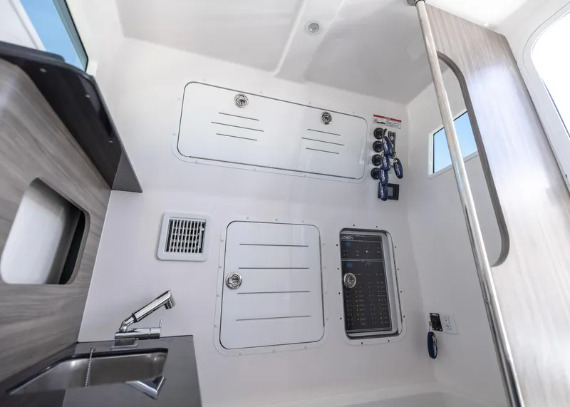 Slide: The Image of Interior of 2025 Invincible 43 Open Fisherman boat, featuring control panels and sink. - 29