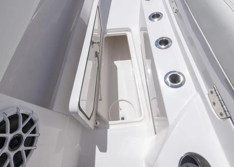 Slide: The Image of 2025 Invincible 43 Open Fisherman boat storage compartment and speaker detail. - 33