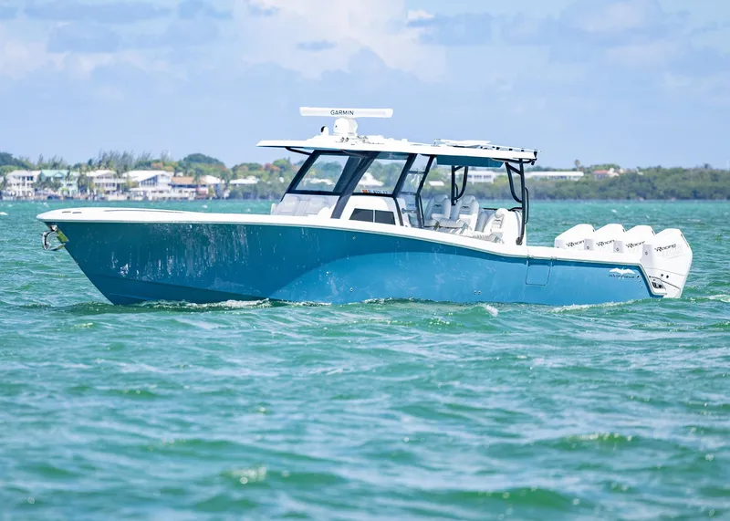Slide: The Image of 2025 Invincible 43 Open Fisherman boat on water, featuring sleek design and multiple engines. - 40