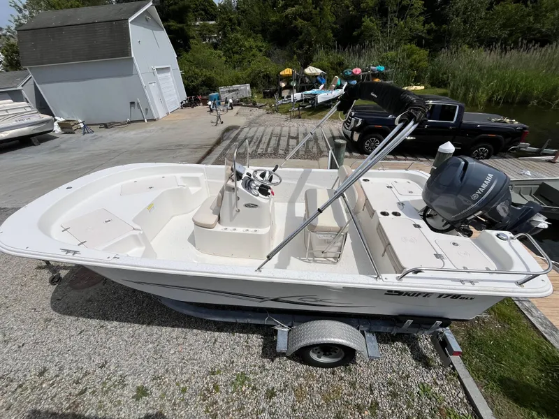 Slide: The Image of 2013 Carolina Skiff 178 DLV boat on trailer, Yamaha motor, outdoor setting. - 0