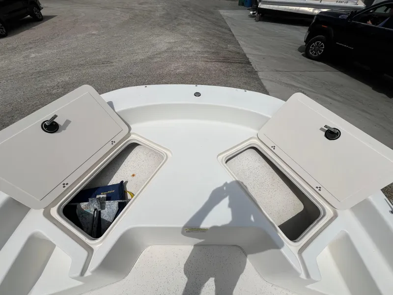 Slide: The Image of 2013 Carolina Skiff 178 DLV boat storage compartments open, showing interior space. - 11