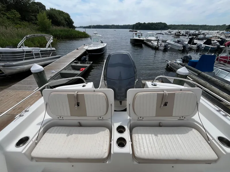 Slide: The Image of 2013 Carolina Skiff 178 DLV boat docked at marina with scenic water view. - 16