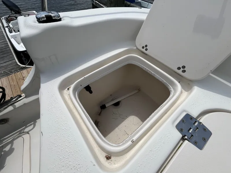 Slide: The Image of Open storage compartment on a 2013 Carolina Skiff 178 DLV boat, dockside view. - 19