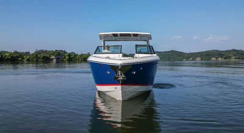 Slide: The Image of 2023 Cobalt R33 boat on a calm lake with scenic background. - 13