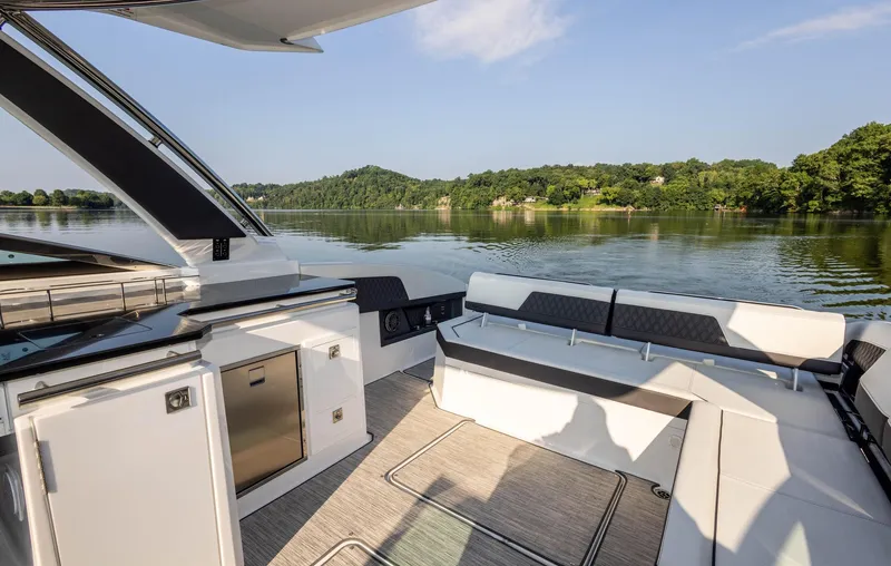 Slide: The Image of Luxurious 2023 Cobalt R33 boat interior with scenic lake view and modern seating. - 15