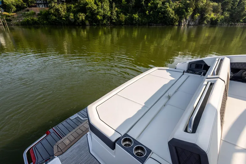 Slide: The Image of 2023 Cobalt R33 boat with luxurious seating on a serene lake. - 18