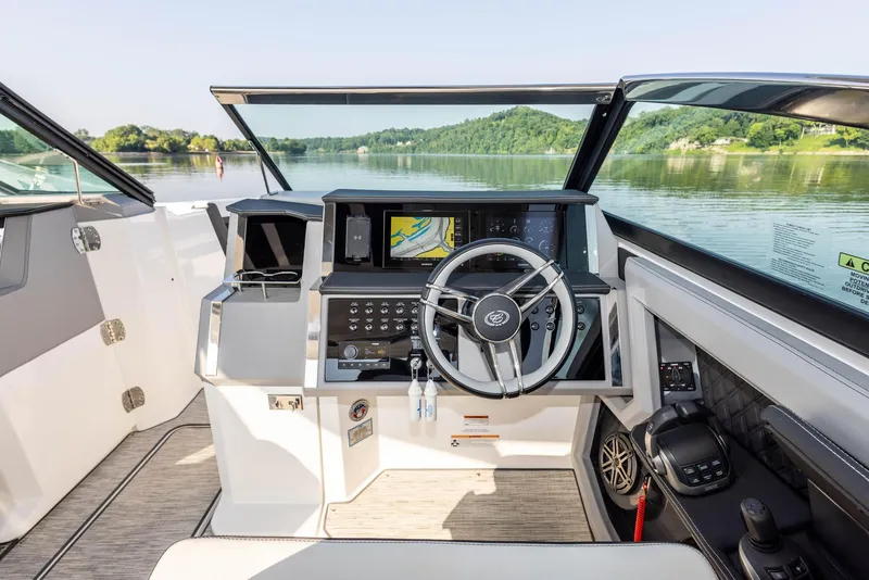 Slide: The Image of Interior view of 2023 Cobalt R33 boat cockpit with steering wheel and navigation system. - 22
