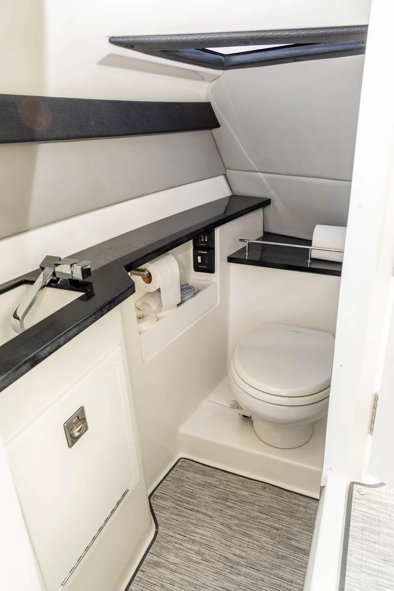 Slide: The Image of 2023 Cobalt R33 boat bathroom with modern fixtures and sleek design. - 28