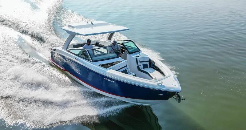 Slide: The Image of 2023 Cobalt R33 boat cruising on calm water, showcasing sleek design and performance. - 4