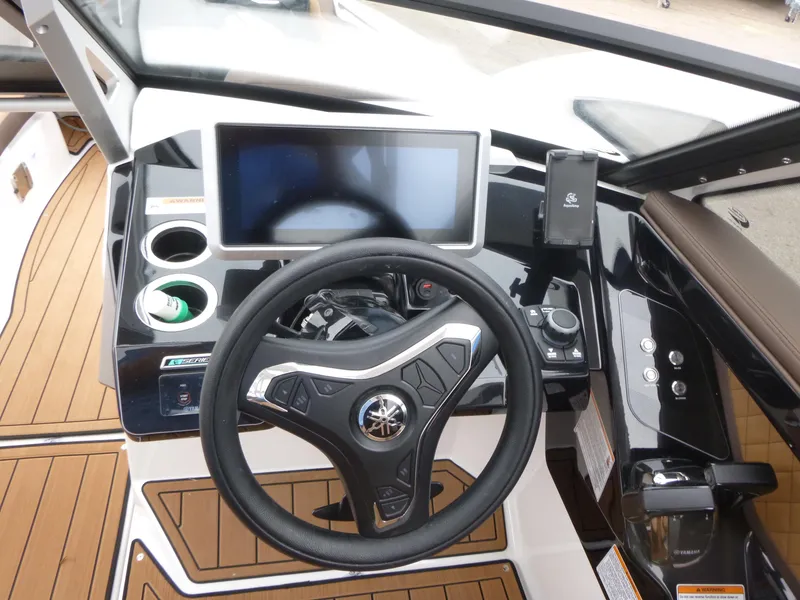 Slide: The Image of 2025 Yamaha Boats 275 SD helm with modern steering wheel and touchscreen display. - 10