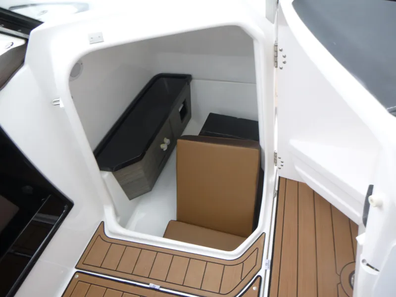 Slide: The Image of Interior cabin of 2025 Yamaha Boats 275 SD with seating and storage. - 12