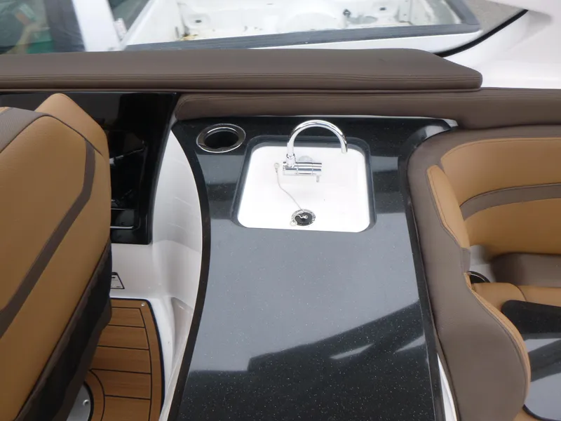 Slide: The Image of 2025 Yamaha Boats 275 SD interior with sink and seating, featuring sleek design and modern amenities. - 8