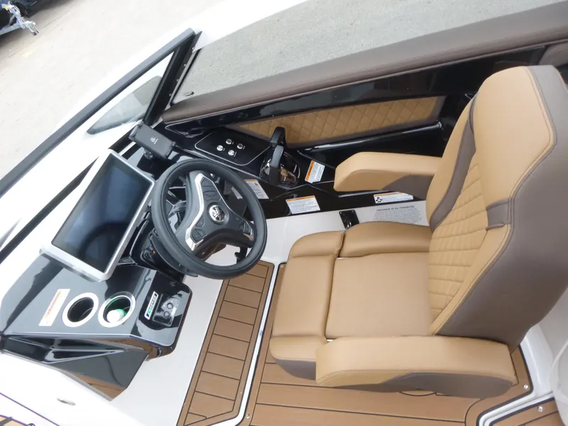 Slide: The Image of 2025 Yamaha Boats 275 SD cockpit with steering wheel, touchscreen, and tan seating. - 9