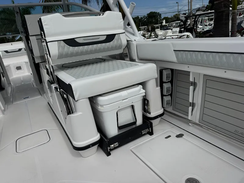 Slide: The Image of 2026 Blackfin 302 DC boat interior with cushioned seating and storage compartments. - 10