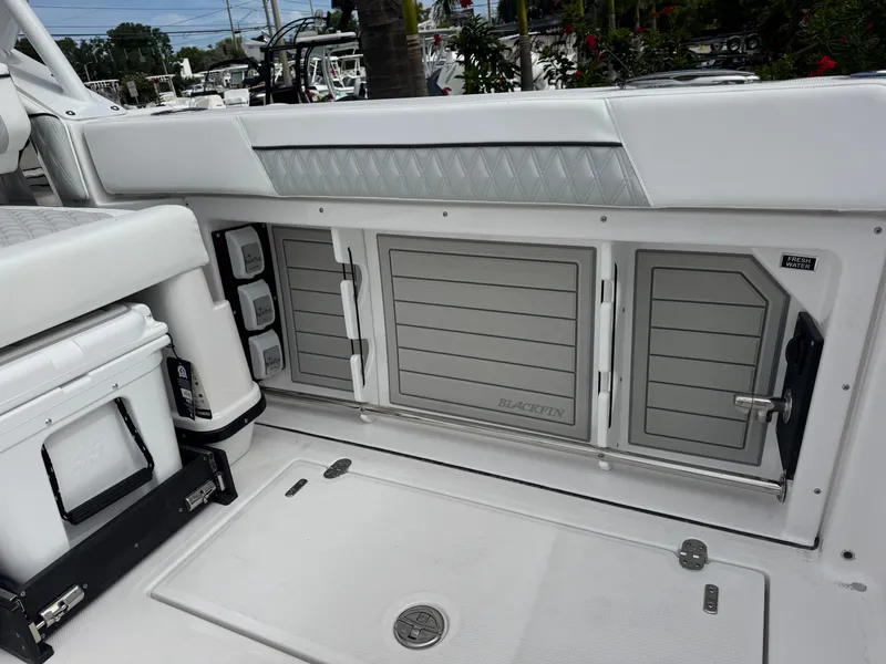 Slide: The Image of 2026 Blackfin 302 DC boat interior with storage compartments and cooler. - 11