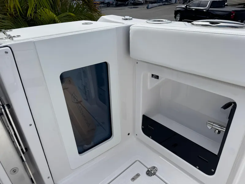 Slide: The Image of 2026 Blackfin 302 DC boat interior storage compartment with sleek white design. - 14