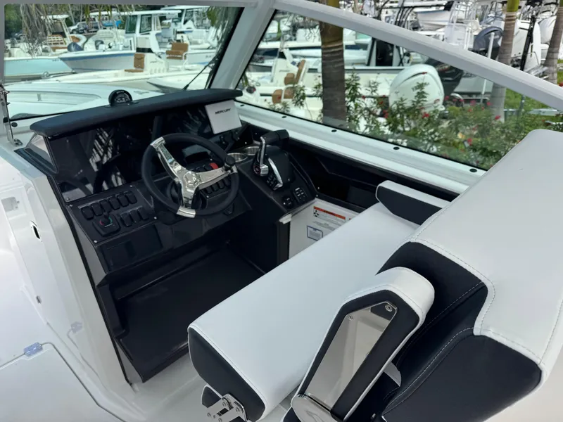 Slide: The Image of Interior view of 2026 Blackfin 302 DC boat cockpit with modern steering and controls. - 18