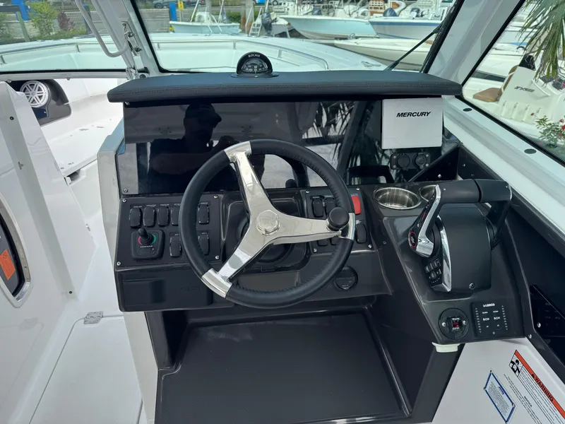 Slide: The Image of Helm of 2026 Blackfin 302 DC boat with steering wheel and controls. - 19