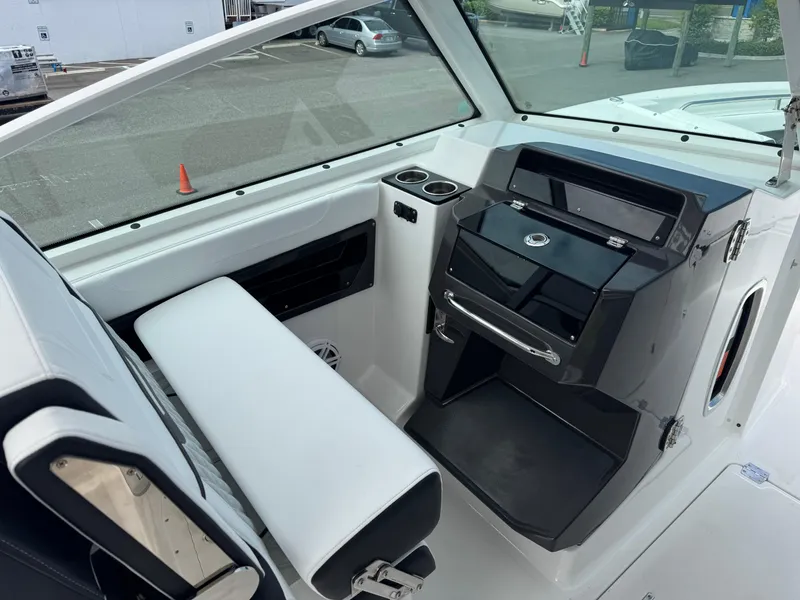 Slide: The Image of Interior view of 2026 Blackfin 302 DC boat, featuring sleek seating and modern dashboard. - 20