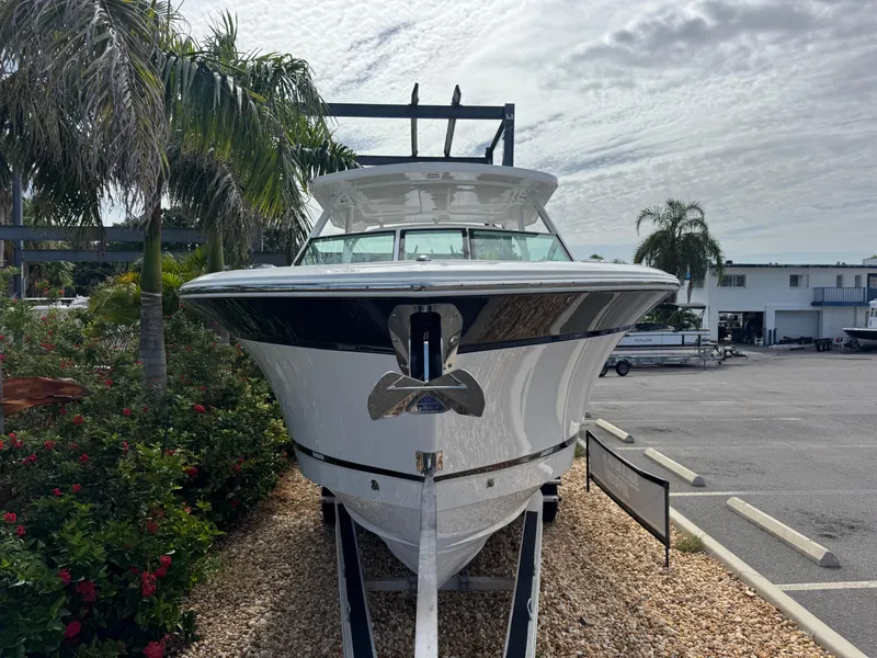 Slide: The Image of 2026 Blackfin 302 DC boat on display, surrounded by palm trees and a cloudy sky. - 4