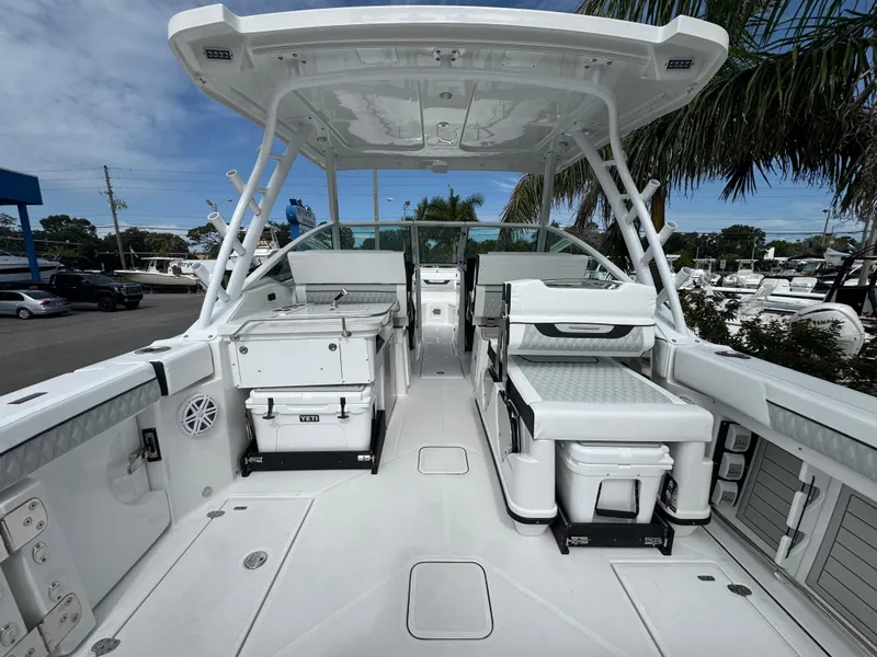 Slide: The Image of 2026 Blackfin 302 DC boat interior with seating and storage, under a clear blue sky. - 8