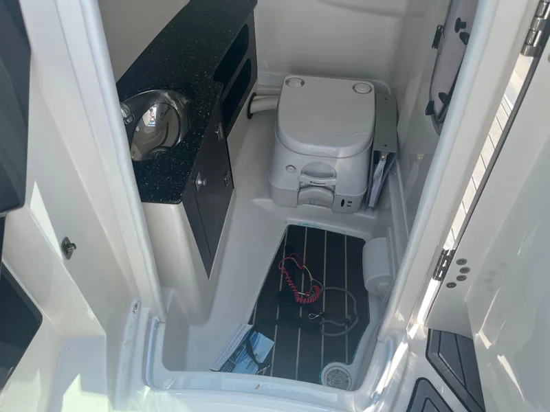 Slide: The Image of Interior of 2014 Monterey 268SS Bowrider boat with compact bathroom amenities. - 19