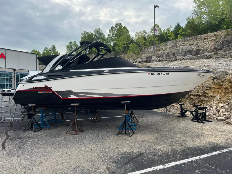 Slide: The Image of 2014 Monterey 268SS Bowrider boat on stands, outdoor setting, overcast sky. - 21