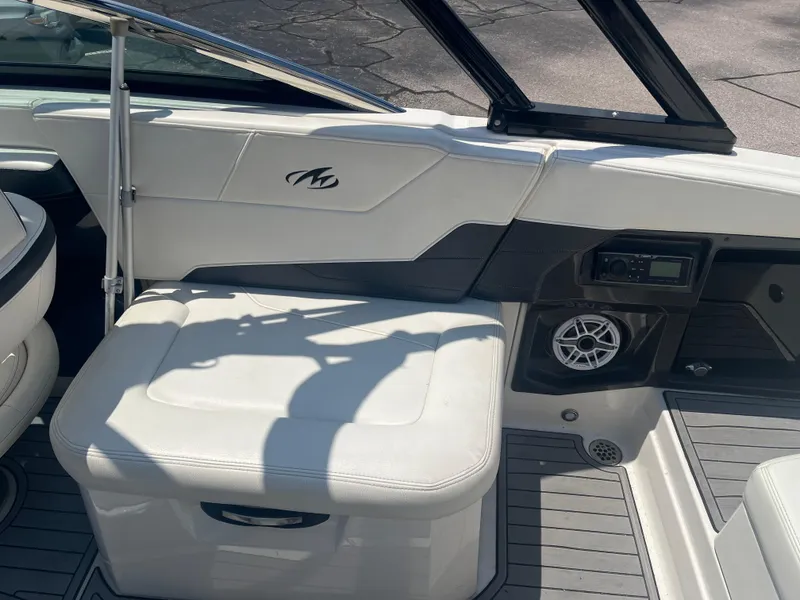Slide: The Image of 2014 Monterey 268SS Bowrider interior with white seating, speaker, and control panel. - 9