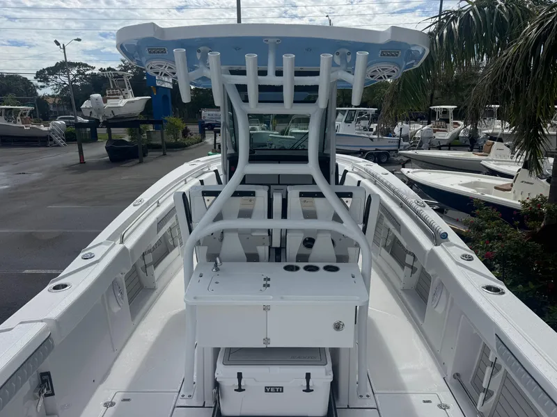 Slide: The Image of 2026 Blackfin 302 CC boat with center console and T-top in a marina setting. - 12