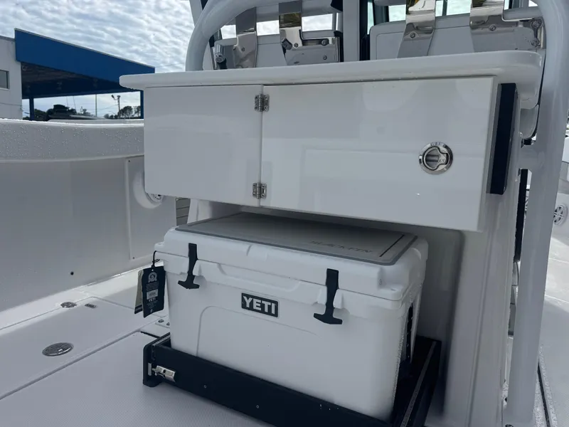 Slide: The Image of 2026 Blackfin 302 CC boat interior with Yeti cooler and storage compartment. - 15