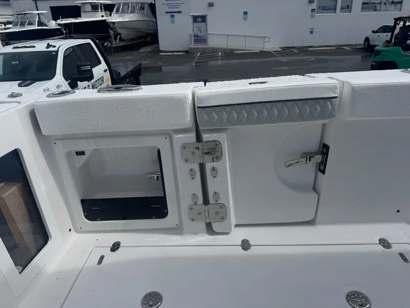 Slide: The Image of 2026 Blackfin 302 CC boat deck with storage compartments and wet surface. - 19
