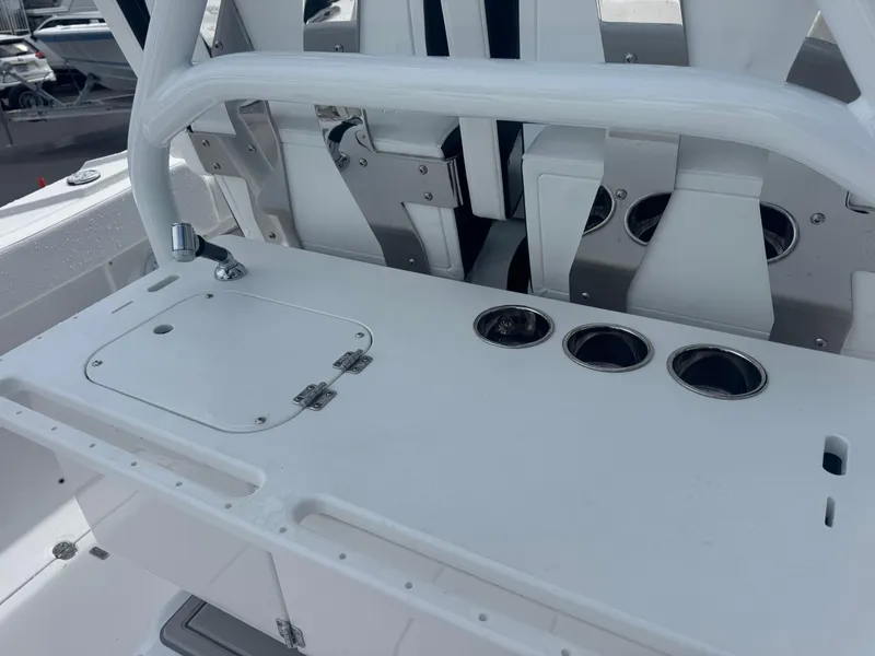 Slide: The Image of 2026 Blackfin 302 CC boat console with cup holders and storage compartment. - 20